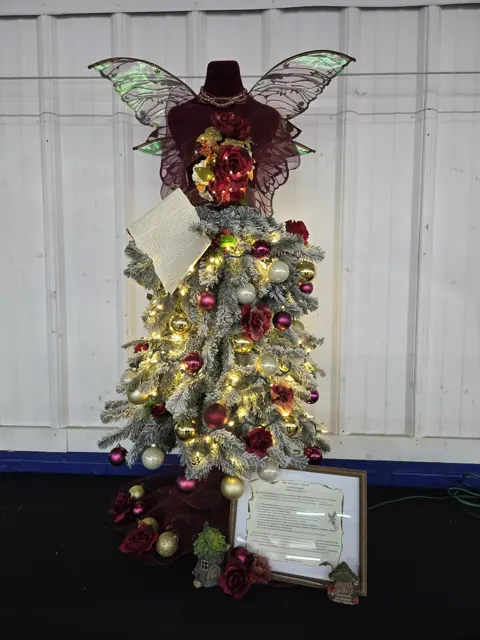 Decorated Christmas tree with a winged topper at BCF