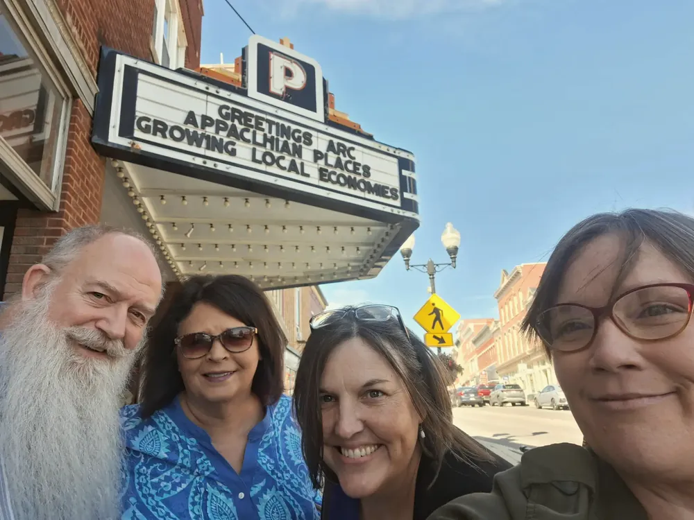 The BCF team under a theater marquee reading Greetings ARC, Appalachian places growing local economies, at the Appalachian Regional Commission conference in Maryland